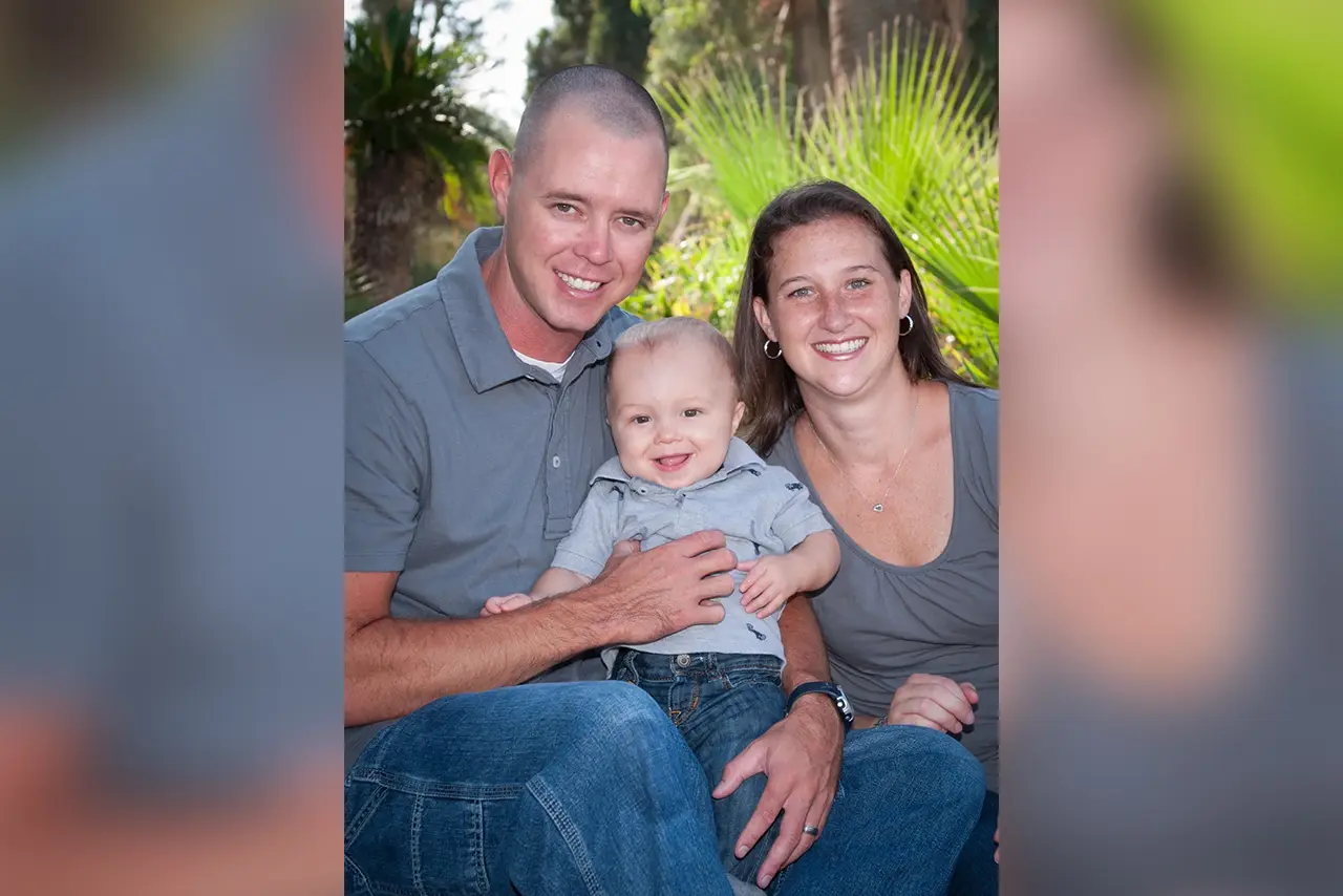 Happy family portrait: mom, dad, and baby.