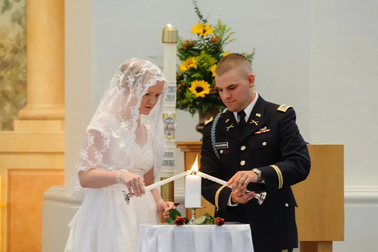 Bride and groom lighting unity candle.